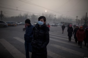 A woman wearing a mask crosses a road during severe pollution in Beijing on January 12, 2013. Air quality data released via the US embassy twitter feed recorded air quality index levels so hazardous that they were classed as 'Beyond Index'. By 4pm the particle matter (PM) 2.5 figure was 728 on a scale that stops at 500 at which point the US embassy website advises against all outdoor activity. AFP PHOTO / Ed Jones (Photo credit should read Ed Jones/AFP/Getty Images)